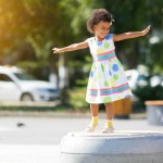 young black girl twirling in a dress