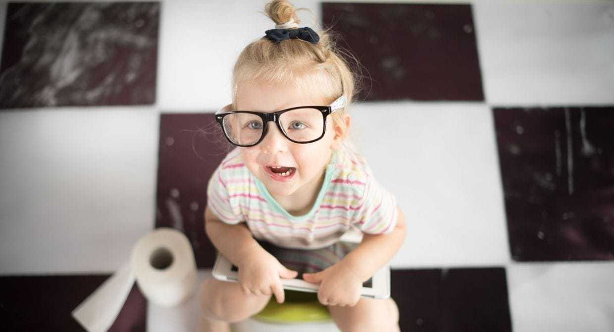 little girl using the potty