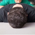 Teen with head on his desk